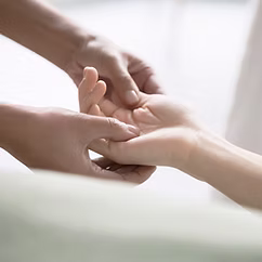 Image of a massage therapist massaging a client's hand.